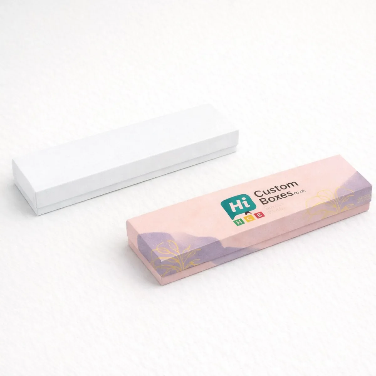 Long- slender rectangular jewellery boxes in plain white and patterned pink for bespoke anklet packaging- class=